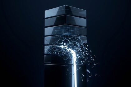 A stack of dark glass blocks with one fracturing and leaking white light